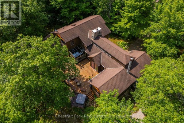 Aerial view of the Georgian Bay home's brown roof, wooden deck, and hot tub. - 257 Sweets Portage Road, Georgian Bay