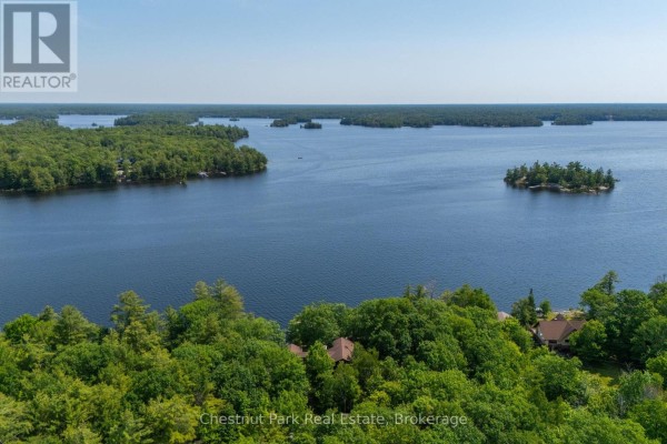 Expansive aerial view of Georgian Bay with islands and the property's treed shoreline. - 257 Sweets Portage Road, Georgian Bay