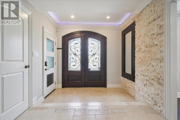 Entryway featuring double doors, stone wall, and modern lighting - 2579 Kenna Court, Mississauga
