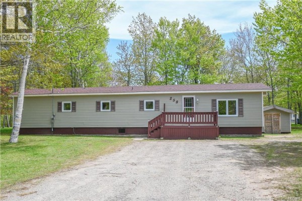 A kitchen island with a speckled countertop and a rustic wooden base in a kitchen with brown cabinets. - 258 Du Bocage Street, Saint Leolin