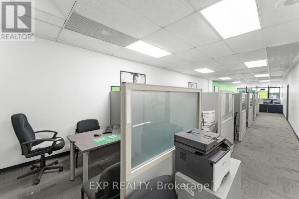 Hallway with cubicles, desks, printers, and partitioned workspaces. - 258 Lakeshore Road E, Mississauga