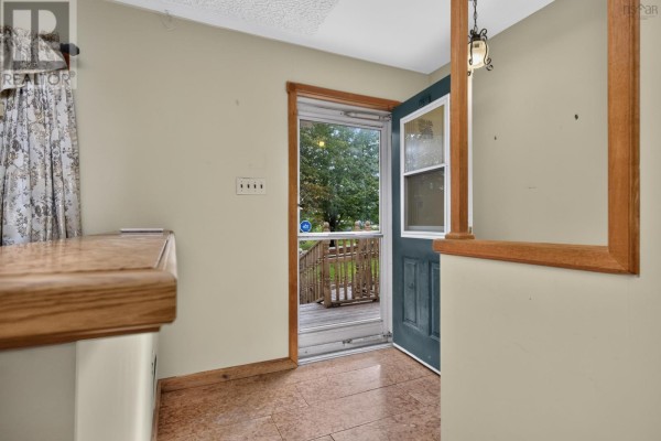 Interior view of the front entrance with a screen door opening to the deck. - 2587 Sackville Drive, Upper Sackville
