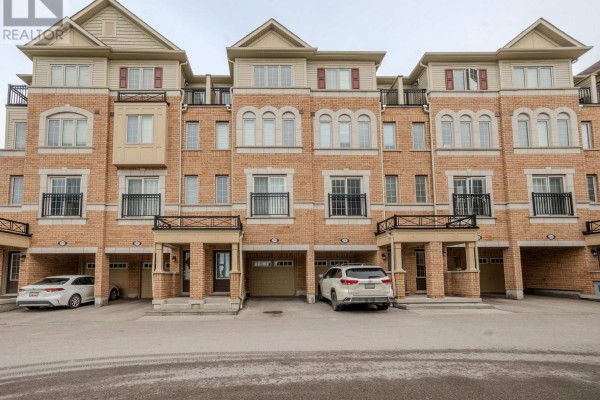 Row of townhouses with balconies and parking spaces - 2589 Bromus Path, Oshawa
