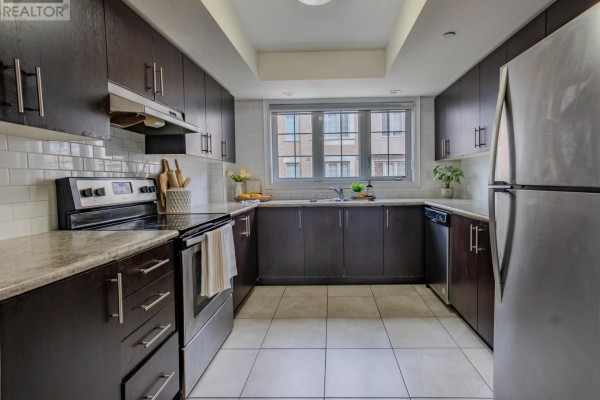 Another view of kitchen showcasing granite countertops and modern fixtures - 2589 Bromus Path, Oshawa