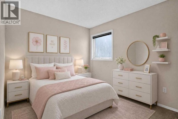 A bedroom with a queen-size bed, pink bedding, and decorative artwork. - 259 Coachway Road Sw, Calgary