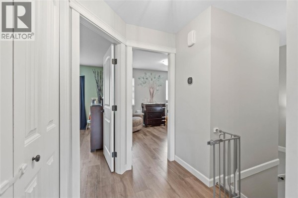 Kitchen with dark wood cabinets, stainless steel appliances, and an island. - 2592 Crestline Street Unit# 9, Kamloops