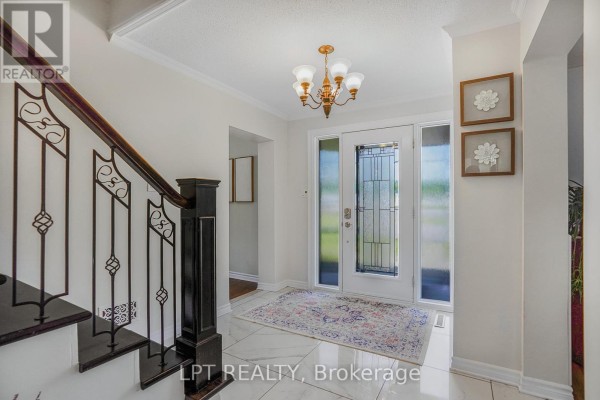Interior foyer with a glass front door, marble tile floor, and a decorative chandelier. - 2598 Highway 34 Road, Hawkesbury