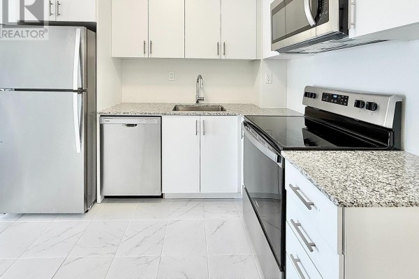 Close-up of the kitchen counter, sink, dishwasher, and electric stove. - 26 - 10 Liben Way, Toronto