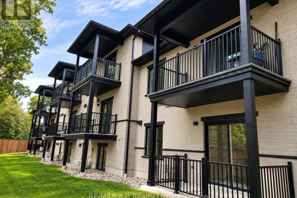 Side view of townhouses showing balconies with black railings and brick exteriors. - 26 - 428 Queen Street W, St  Marys