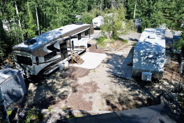 Gazebo with black roof and support posts situated near a terraced garden bed. - 26 & 27 53213 Hghway 31, Rural Parkland County
