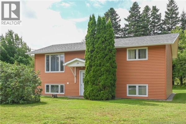 Kitchen with white cabinets, white appliances, and a large wooden hutch. - 26 Des Patriotes Street, Caraquet
