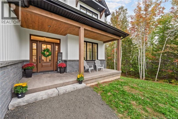 Covered front porch with wood ceiling, grey stone base, and two chairs. - 26 Maefield Street, Lower Coverdale