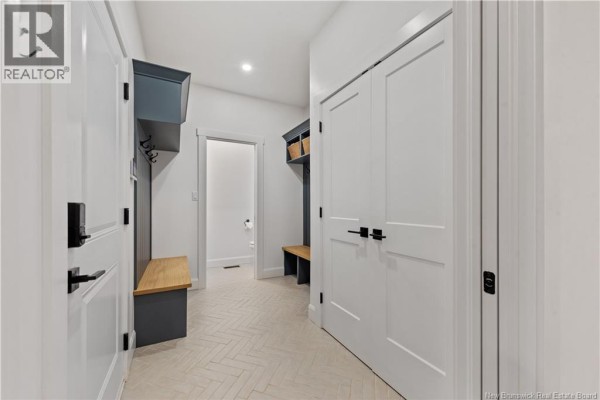 Hallway with white doors and built-in grey cubbies and wooden benches. - 26 Maefield Street, Lower Coverdale