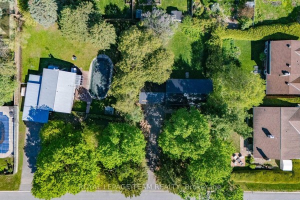 Aerial view of two artist renderings of modern brick townhomes with garages on a tree-lined street. - 26 Maple Grove Road, Ottawa