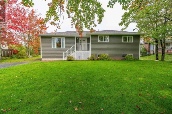 Front view of a grey, one-story house with white trim and a green lawn. - 26 Poplar Drive, Lantz