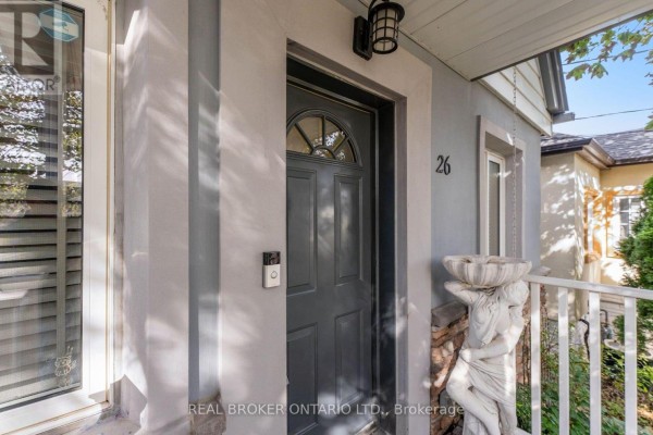 Close-up of the front door of the house, painted dark grey with a glass insert. - 26 Roxaline Street, Toronto