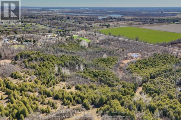 Aerial view of the property adjacent to Smiths Falls Golf & Country Club with water features. - 26 Salmon Side Road, Rideau Lakes