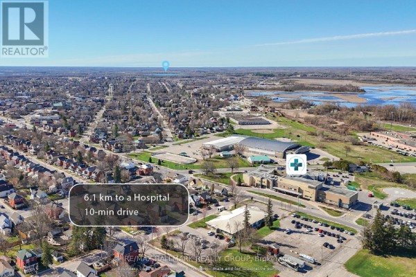Aerial view of the property's proximity to a shopping center with Food Basics and other retail stores. - 26 Salmon Side Road, Rideau Lakes