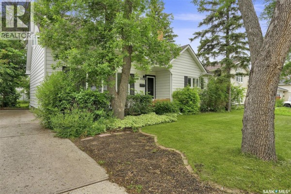 Driveway and pathway leading to the front entrance of the white siding house. - 26 Scott Street, Regina