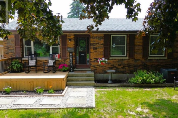 Front view of a brick house with a wooden deck and walkway in the front yard. - 26 Sinclair Avenue, St  Thomas