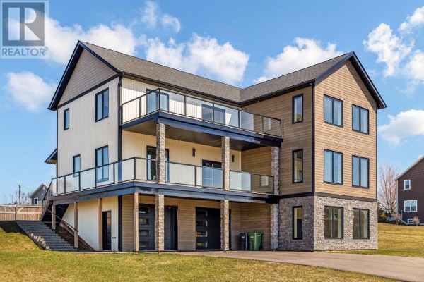 Three-story house with varied siding materials, balconies, and a lower-level garage. - 26 Strawberry Lane, Stratford