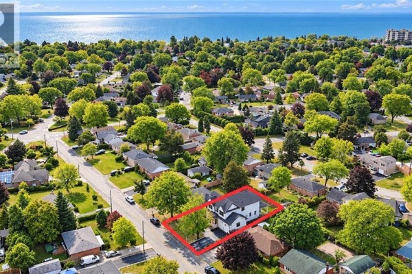 Aerial view of 260 Kent Crescent, Burlington, surrounded by trees and near water. - 260 Kent Crescent, Burlington