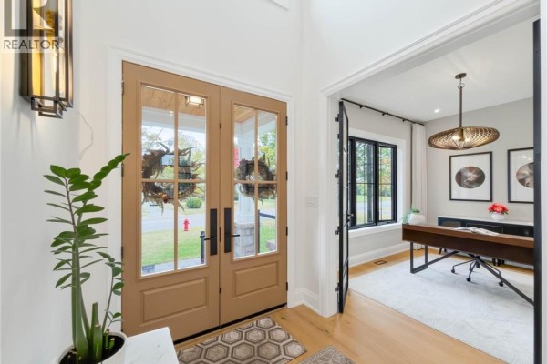 Foyer with double glass doors and view into a modern office with desk. - 260 Kent Crescent, Burlington