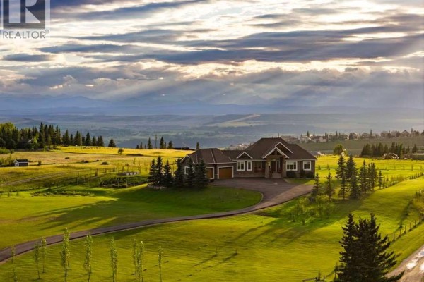Aerial view of the large residential property nestled in a rural landscape. - 260169 Mountain Ridge Place, Rural Rocky View County