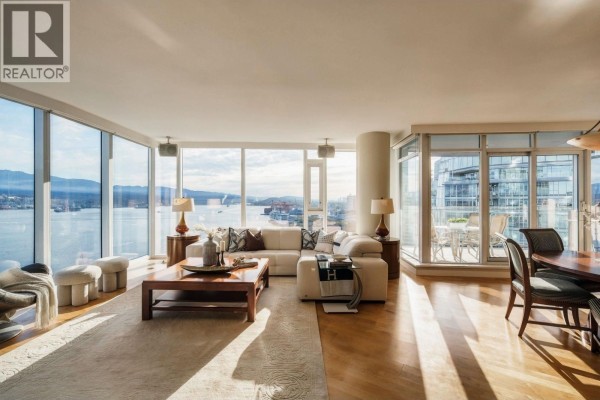 Living and dining area with large windows, hardwood floors, and city and water views. - 2602 1281 W Cordova Street, Vancouver
