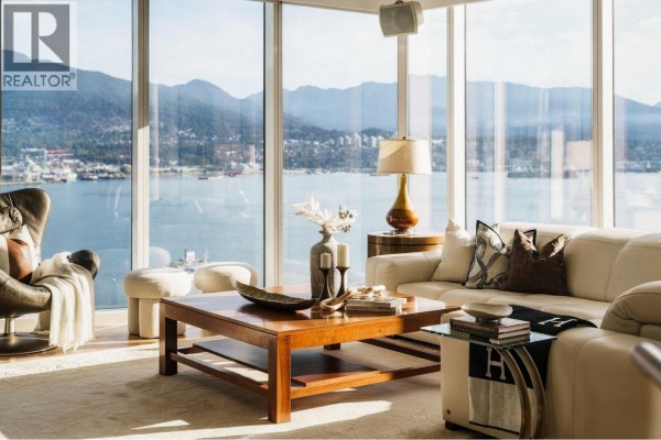Living room corner with leather armchair, fireplace, and stunning city and ocean vistas. - 2602 1281 W Cordova Street, Vancouver