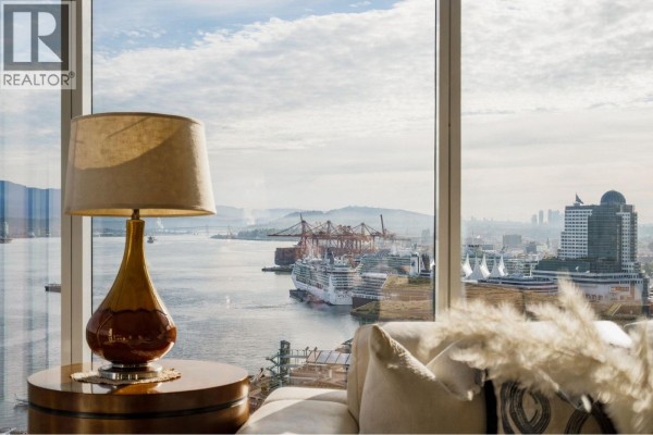 Close-up of a lamp on a side table, with a view of ships in the harbor. - 2602 1281 W Cordova Street, Vancouver