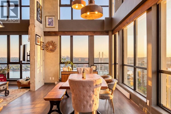 Open concept kitchen and dining area with high ceilings, large windows, and city views. - 2603 271 Francis Way, New Westminster