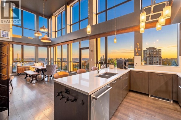 Spacious dining area with a wooden table, bench, and chairs, large windows, and city views. - 2603 271 Francis Way, New Westminster