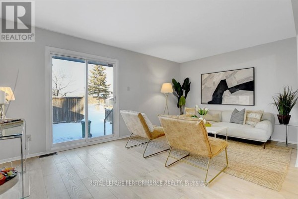 Small bedroom with light wood floors, grey walls, and a horizontal window. - 2603 Pimlico Crescent, Ottawa