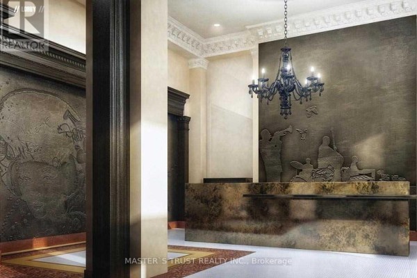 Lobby reception desk with textured metallic finish and ornate chandelier. - 2609 - 197 Yonge Street, Toronto