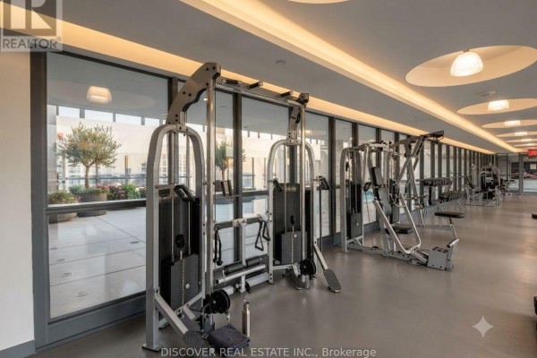 Gym with weight machines and large windows overlooking an outdoor patio. - 2609 - 215 Fort York Boulevard, Toronto