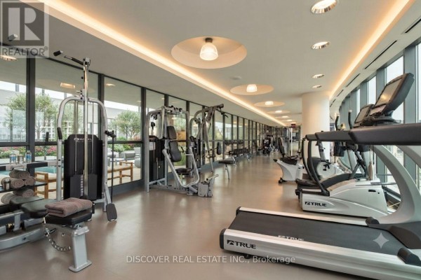 Gym with treadmills, weight machines, and panoramic windows with city views. - 2609 - 215 Fort York Boulevard, Toronto