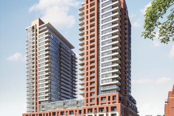 Exterior of modern apartment towers with red brick and glass balconies under a blue sky. - 2609 - 4010 Eglinton Avenue W, Toronto