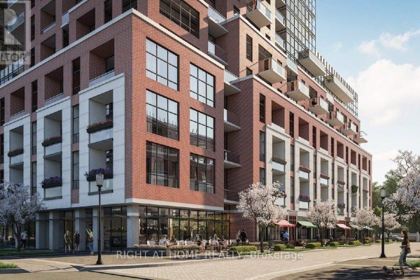 Ground level view of apartment building with red brick, white stone accents, and large windows. - 2609 - 4010 Eglinton Avenue W, Toronto