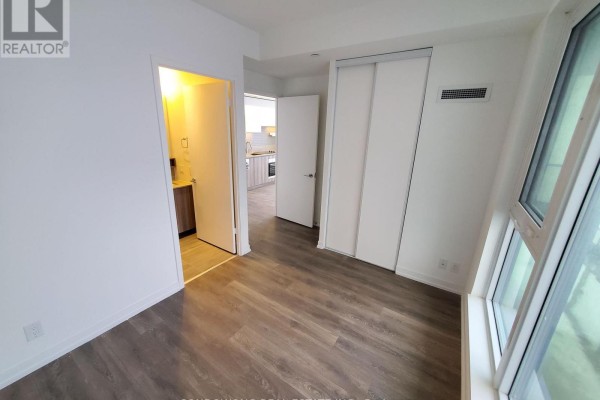 View of entryway and hallway from a bedroom with mirrored closet doors. - 2610 - 5 Buttermill Avenue, Vaughan