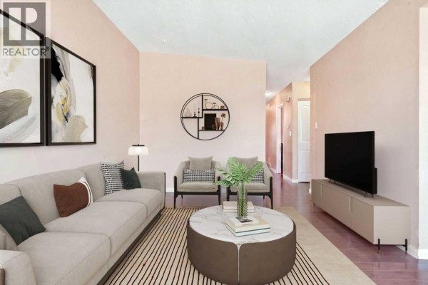 Living room with a gray sofa, two armchairs, and a round marble coffee table. - 2615/2613 39 Street Se, Calgary