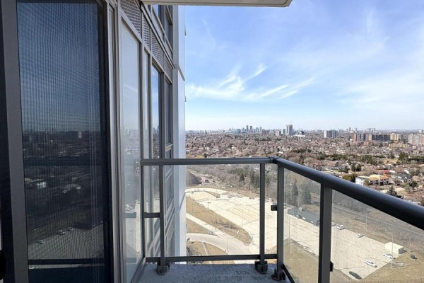 Balcony with glass railing overlooking a cityscape and distant buildings. - 2619 - 2031 Kennedy Road, Toronto