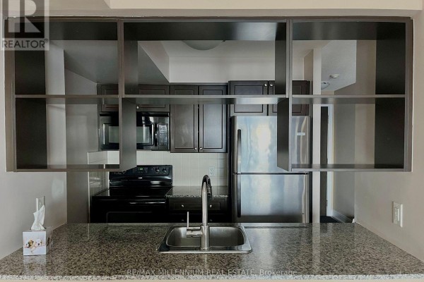 View of the kitchen sink and granite countertop from the living room. - 2621 - 135 Village Green Square, Toronto