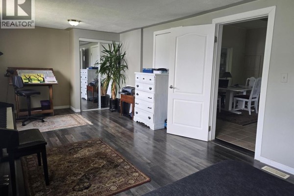 Dining area featuring a window view, white furniture, and access to hallway. - 263 Delaware Avenue, Chatham