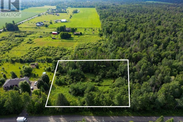 Aerial perspective of rural property showing treed lot with homes and fields. - 2630 Mcmullen Road, Ottawa