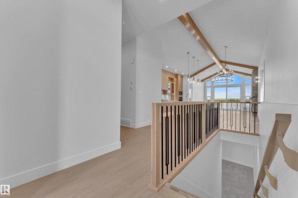 Spacious living room with vaulted ceilings, stone fireplace, and large windows. - 264 Falcon Crescent, Leduc