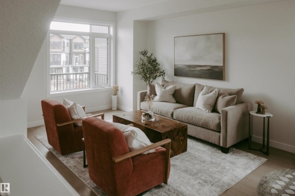 Open concept living and kitchen area with a large island and stainless steel appliances. - 2641 Alces Wy Sw, Edmonton