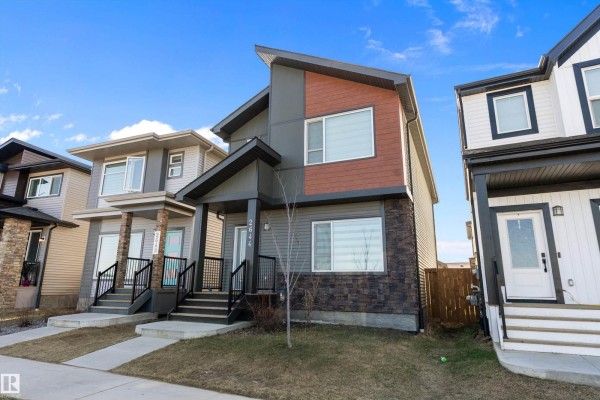 Side view of the house highlighting the contemporary architecture and neighboring homes. - 2644 192 St Nw, Edmonton