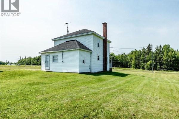 View from inside a two-car garage showing two open garage doors and a storage area. - 2649 Saint-ignace, Saint Ignace