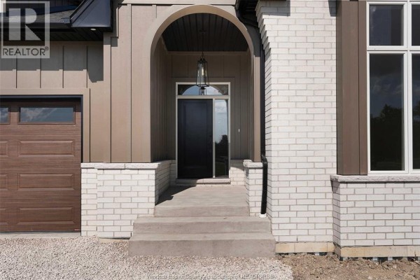 Close-up of the front entrance with steps, a dark door, and a hanging lantern light. - 265 Charles Street, Essex
